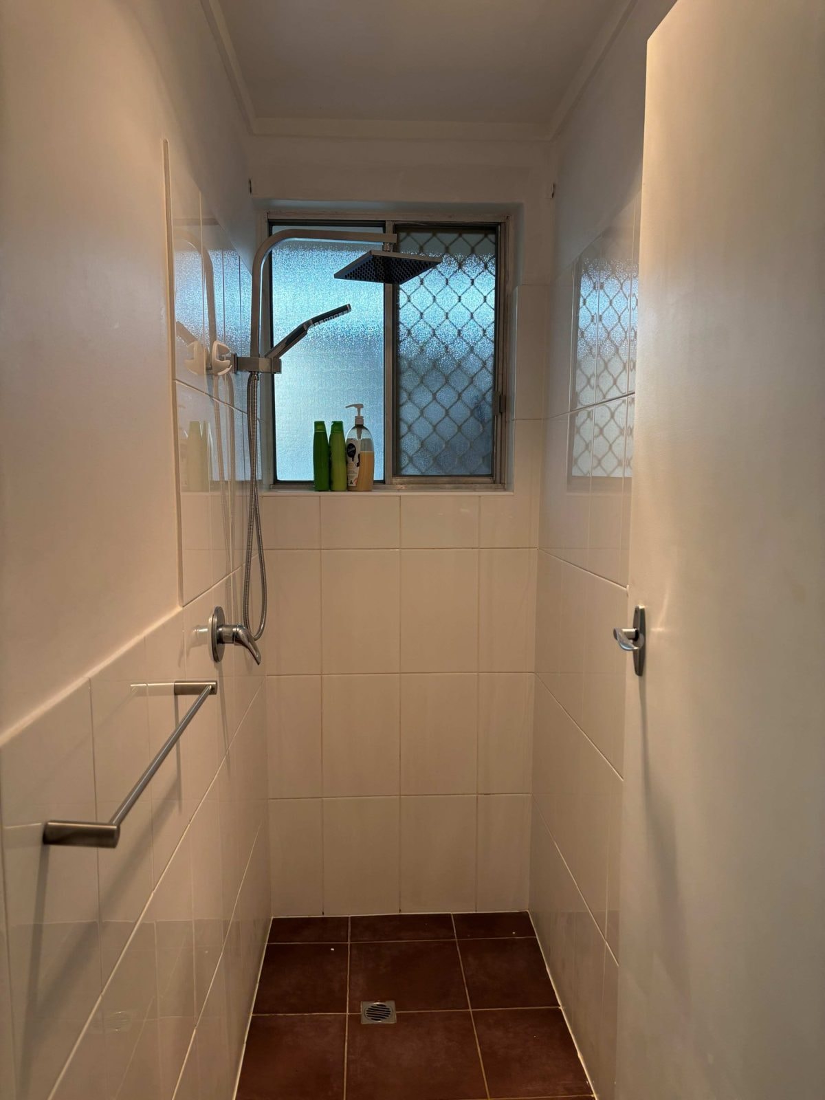 Bathroom of a CISP SIL home with a tiled shower and vanity
