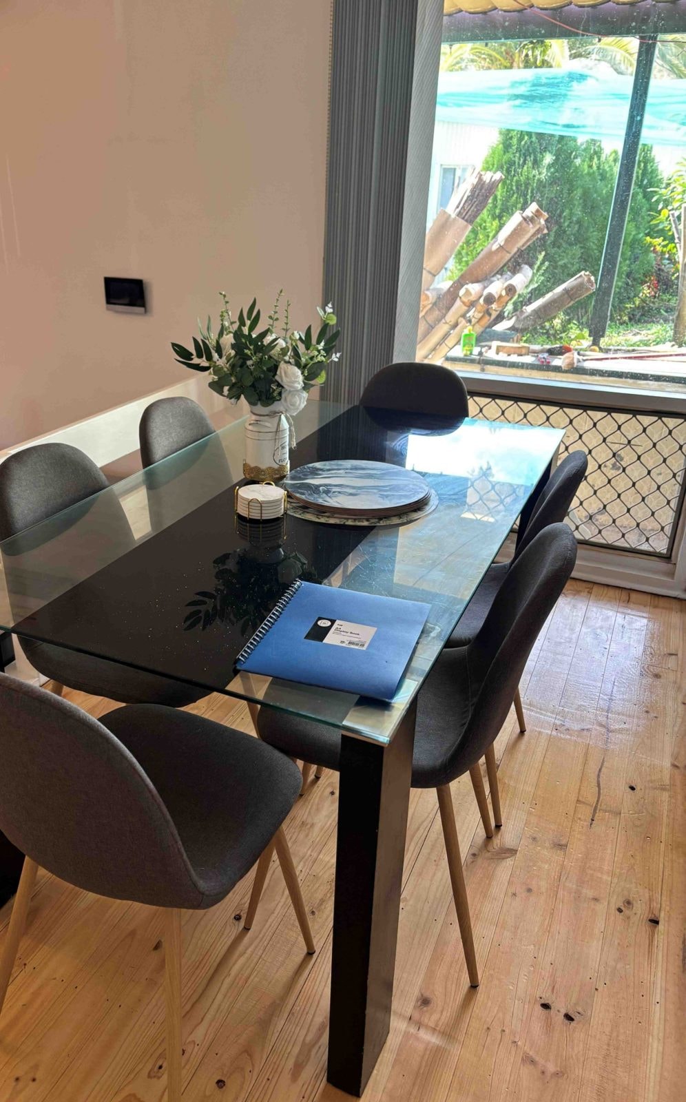 Dining area of a CISP SIL home with a glass dining table and chairs
